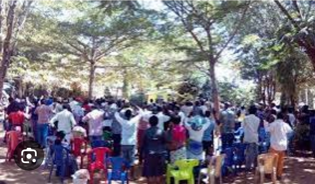 Early worship under the trees in Kahama